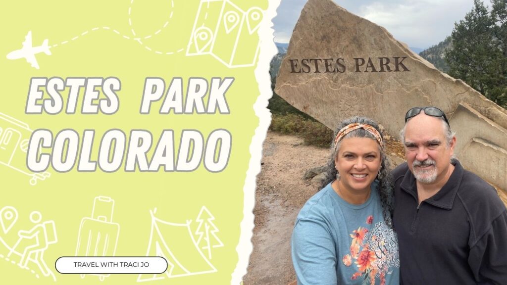 couple standing in front of rock that says Estes Park